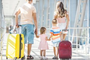 Family with suitcases in airport