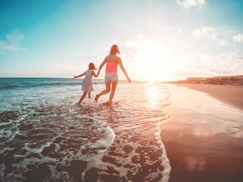 mum and daughter on holiday at beach